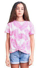 Obraz premium Cute hispanic child girl wearing casual clothes relaxed with serious expression on face. simple and natural looking at the camera.