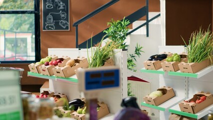 Fresh fruits and vegetables in crates at local bio supermarket, empty zero waste eco store filled...