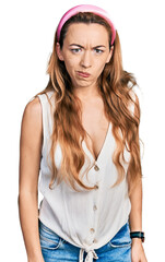 Young caucasian woman wearing casual style with sleeveless shirt skeptic and nervous, frowning upset because of problem. negative person.