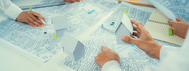 Worker, architect and engineer work on real estate construction project oratory planning with...