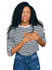 Middle age african american woman wearing casual clothes smiling with hands on chest with closed eyes and grateful gesture on face. health concept.