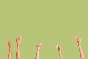 Women with pink ribbons on green background. Breast cancer awareness concept