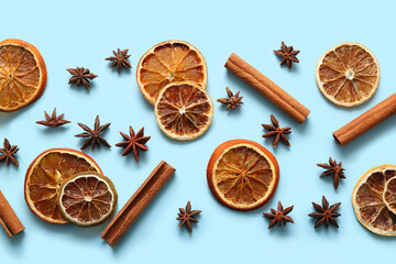Dried orange slices with star anise and cinnamon on blue background