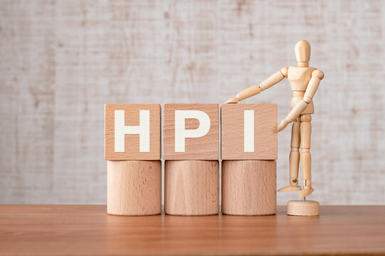 There is wood cube with the word HPI. It is an abbreviation for Human, Performance, Improvement as eye-catching image.