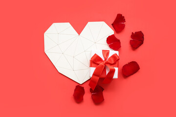 Heart with gift box and rose petals on red background