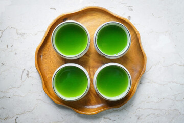 Japanese green matcha tea cups on serving tray on marble