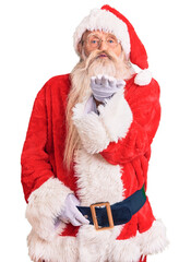 Old senior man with grey hair and long beard wearing traditional santa claus costume looking at the camera blowing a kiss with hand on air being lovely and sexy. love expression.