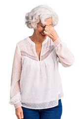 Senior grey-haired woman wearing casual clothes tired rubbing nose and eyes feeling fatigue and headache. stress and frustration concept.