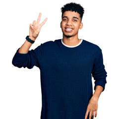 Young african american man wearing casual clothes showing and pointing up with fingers number two while smiling confident and happy.