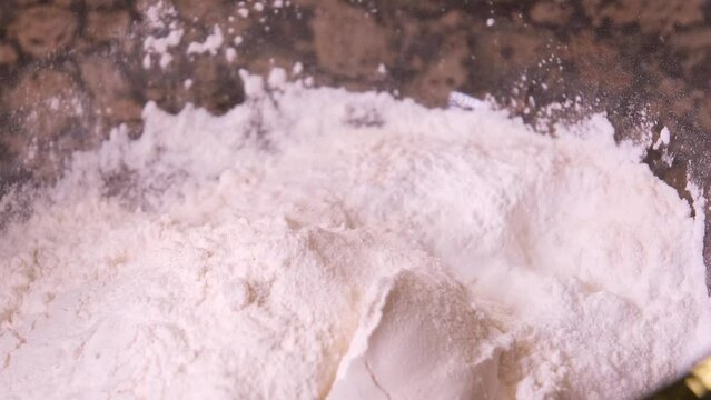 In a transparent bowl with eggs, I pour a tablespoon of milk to prepare the dough. High quality 4k footage. High quality 4k footage