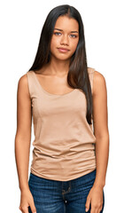 Fototapeta premium Beautiful hispanic woman wearing casual clothes relaxed with serious expression on face. simple and natural looking at the camera.