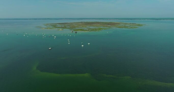 Aerial view of estuary wetland bay along ocean in Bassin d'Arcachon bay in France. Oyster farms.