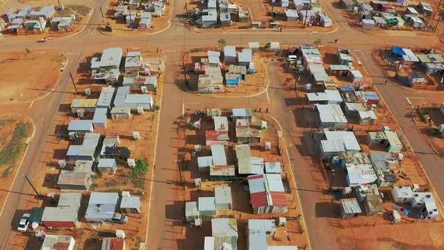 Drone, township and poor neighborhood or rural infrastructure, development and third world settlement. Aerial, community and poverty or village, outdoors and dirt in environment or project housing