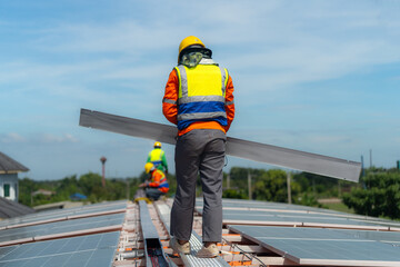 Worker Technicians are working to construct solar panels system on roof. Installing solar photovoltaic panel system. Alternative energy ecological concept. Renewable clean energy technology concept.