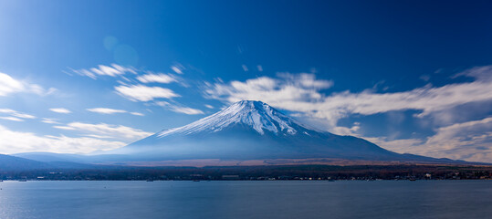 Long exposure shot of Mt. Fuji with snow cap and Lake Yamanakako at daytime.