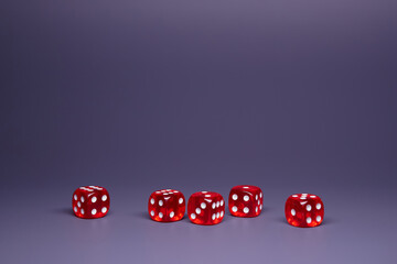 Red dices on grey background. Copy space.