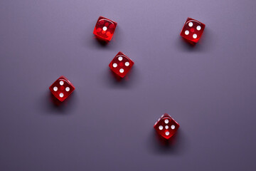 Red dices on grey background. Copy space.