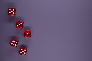 Red dices on grey background. Copy space.