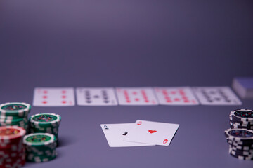 Dealer or croupier shuffles poker cards in a casino on the background of a table, chips. Concept of poker game, game business. Playing for money, a big win, a jackpot, gambling, a desire to get rich.	