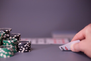 Dealer or croupier shuffles poker cards in a casino on the background of a table, chips. Concept of poker game, game business. Playing for money, a big win, a jackpot, gambling, a desire to get rich.	
