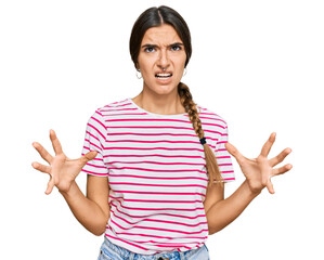 Young hispanic woman wearing casual clothes crazy and mad shouting and yelling with aggressive...