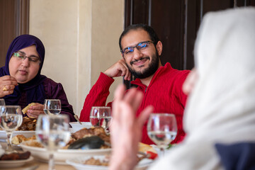 Family eating together with multi generation members in modern living room