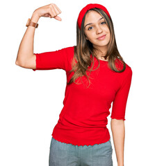 Obraz na płótnie Canvas Young brunette woman wearing casual clothes strong person showing arm muscle, confident and proud of power