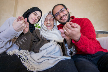 mother father and grandmother as a happy family in modern living room