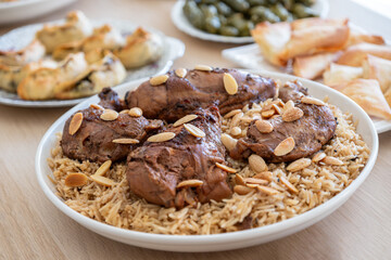 arabian dining table consist of rolls of cabbage rolls of grape , rice ,chicken, sambousek and qatayef without people