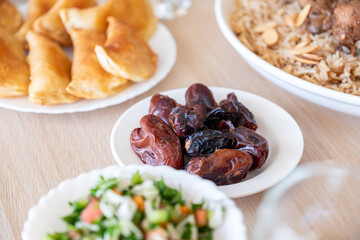 Dates on dining table served with rice and water for iftar  with arabian food