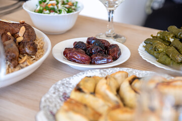 Dates on dining table served with rice and water for iftar  with arabian food
