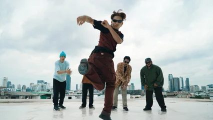  Professional asian street dancer practice B boy dance while multicultural friends at roof top. Young modern dancing group doing hip hop movement. Style,fashion,action. Outdoor sport 2024. Endeavor. © Summit Art Creations