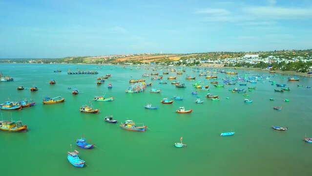 Fishing village in Mui Ne, Vietnam. Mui Ne Fishing Village, flying around several hundred fishing boats anchored to avoid storms, is a beautiful bay in central Vietnam. Asia fishing boats. 4K