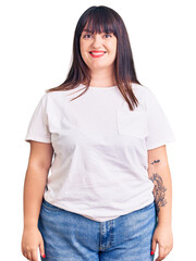 Obraz premium Young plus size woman wearing casual clothes with a happy and cool smile on face. lucky person.