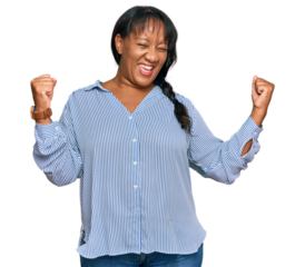 Hispanic middle age woman wearing casual clothes very happy and excited doing winner gesture with arms raised, smiling and screaming for success. celebration concept.