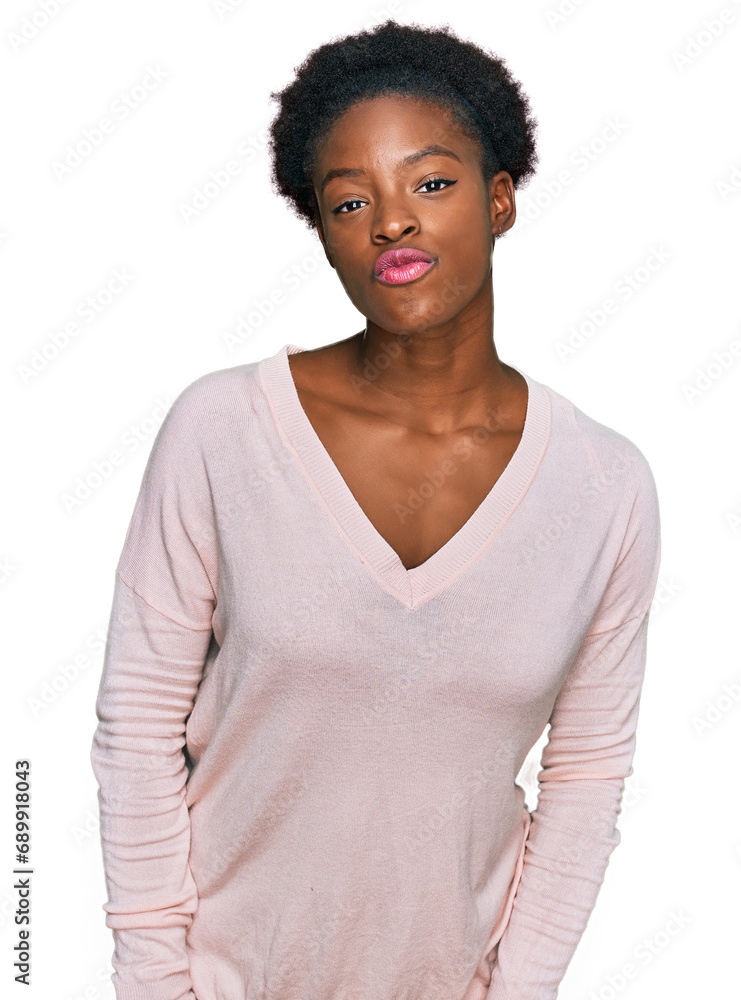 Poster Young african american girl wearing casual clothes looking at the camera blowing a kiss on air being lovely and sexy. love expression.