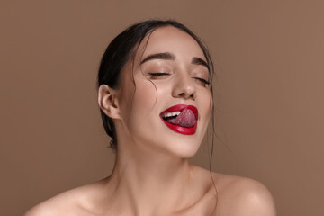 Portrait of beautiful woman on brown background, closeup