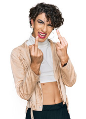Handsome man wearing make up and woman clothes showing middle finger doing fuck you bad expression,...
