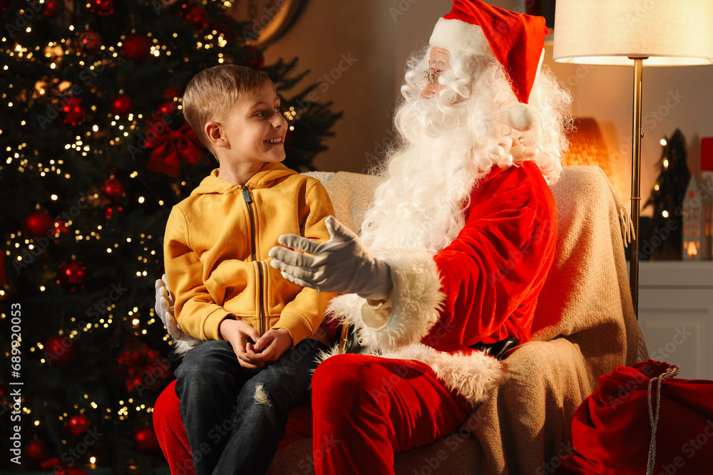 Wall mural Merry Christmas. Little boy with Santa Claus in room