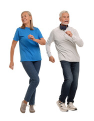 Senior couple dancing together on white background