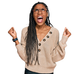 African american woman wearing casual clothes crazy and mad shouting and yelling with aggressive...
