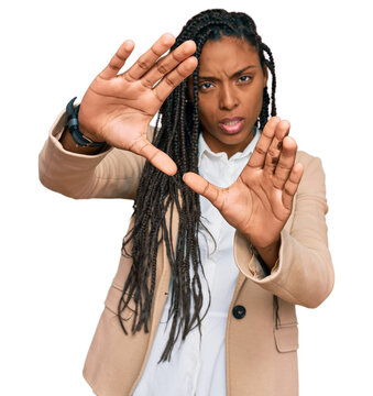 African american woman wearing business jacket doing frame using hands palms and fingers, camera perspective
