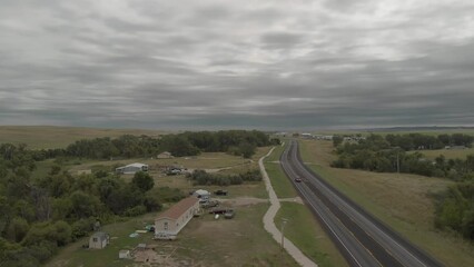 Vehicles and cars driving on the highway running through Pine Ridge Reservation Road, drone aerial view