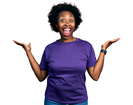 African american woman with afro hair wearing casual purple t shirt celebrating crazy and amazed for success with arms raised and open eyes screaming excited. winner concept