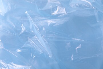Texture of light blue plastic bag as background, closeup