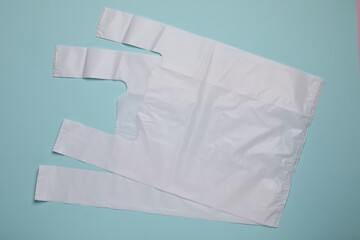 Two plastic bags on turquoise background, flat lay. Space for text