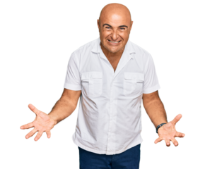 Mature middle east man with mustache wearing casual white shirt smiling cheerful with open arms as friendly welcome, positive and confident greetings