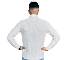 Young arab man with beard wearing elegant turtleneck sweater and glasses standing backwards looking away with arms on body