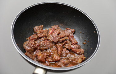 Korean BBQ, marinated meats grilling on a hot plate, emitting flavorful smoke, vibrant colors in a bustling eatery