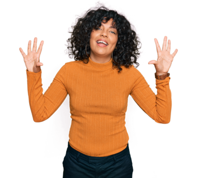 Young hispanic woman wearing casual clothes showing and pointing up with fingers number ten while smiling confident and happy.